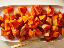 An overhead image of halved squash rings topped with tofu and herbs.