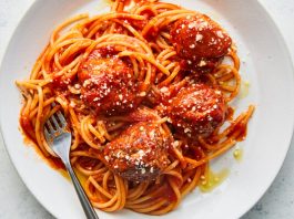 An overhead image of a plate of spaghetti and meatballs.