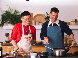 Bowen Yang Shares His Mom’s Mapo Tofu Recipe Bowen Yang and Matt Rogers stand at a kitchen island. Mr. Yang prepares to cut a block of tofu.