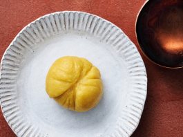 A yellow swallow on a white plate.