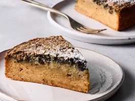 A side image of a cake with a layer of black sesame on top.